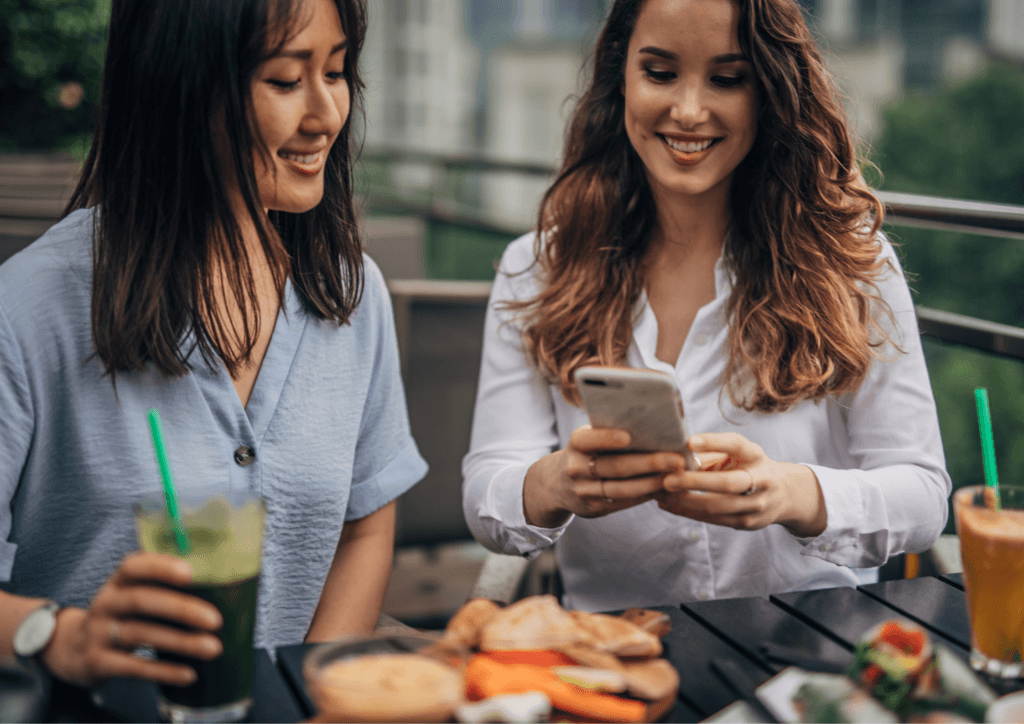 people choosing restaurant on their phone